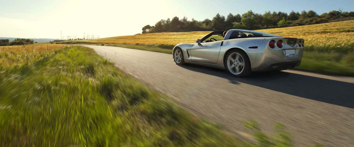 Sporty driving in a Corvette or Ferrari on the road in Valencia